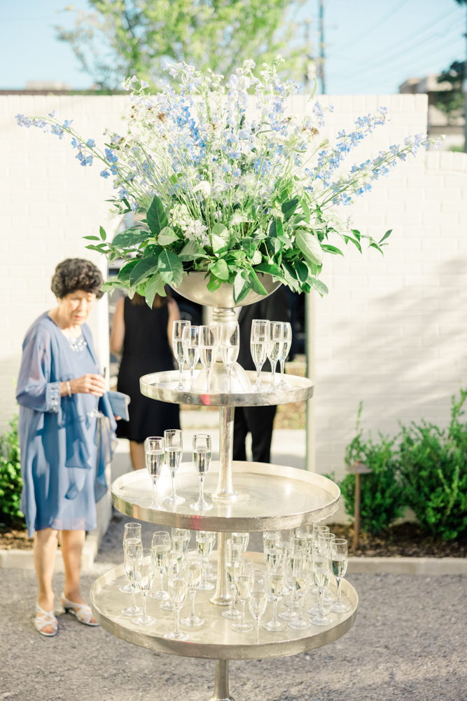 A lady enjoys a glass of champagne from this champagne display at The Farrell.