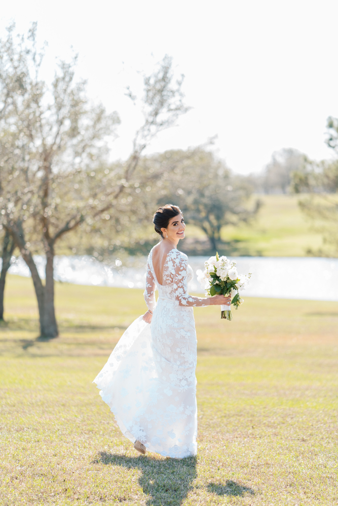 The bride wears a sleeved gown from Ivory & White Bridal Boutique for her Southern wedding.