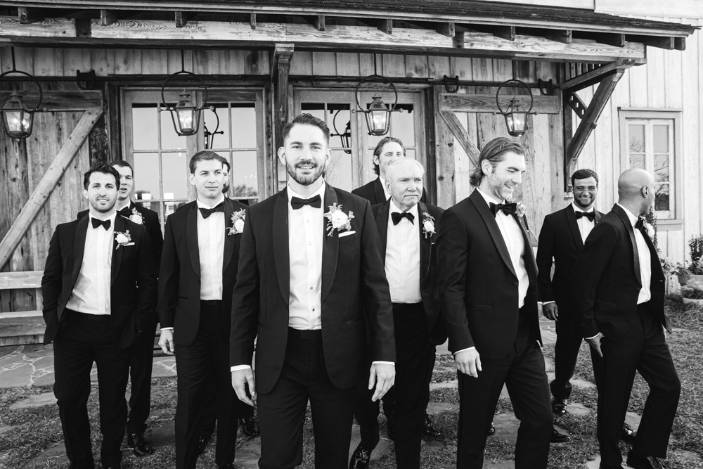 The groomsmen walk together to the wedding ceremony in Fairhope.