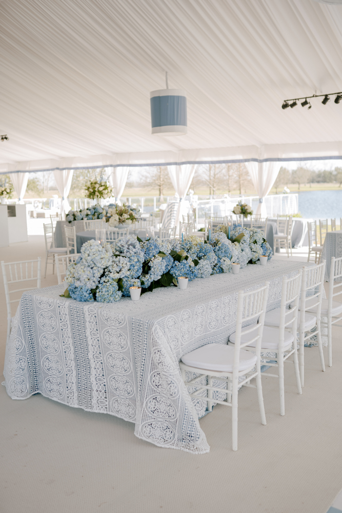 This blue and white Southern wedding reception is set in a custom tent in Fairhope, Alabama.