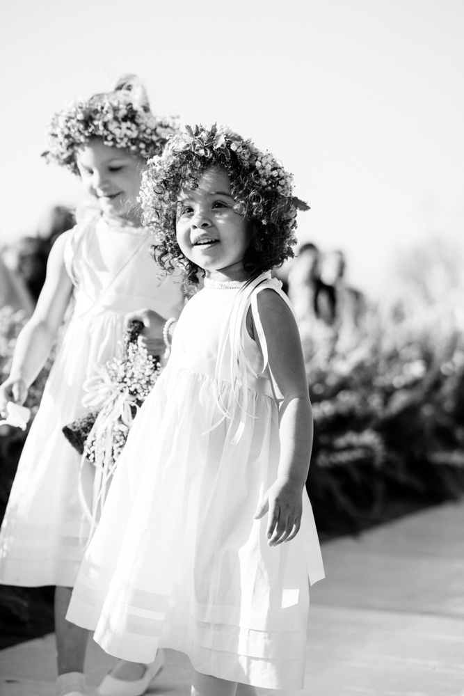 Two darling flowers girls walk down the aisle at this Southern wedding.