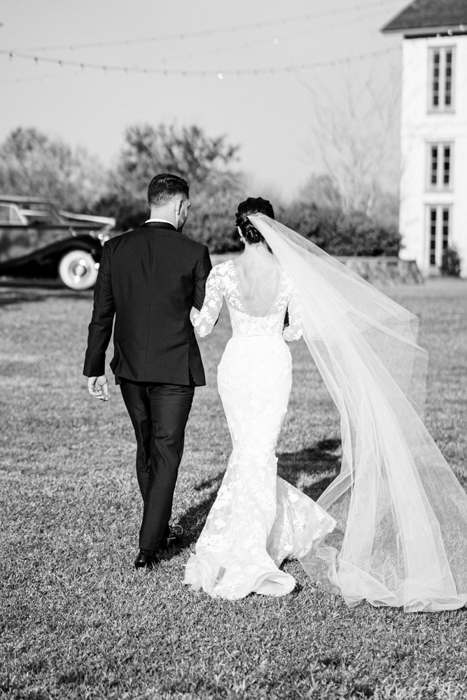 The bride and groom walk together after their wedding ceremony in Alabama.