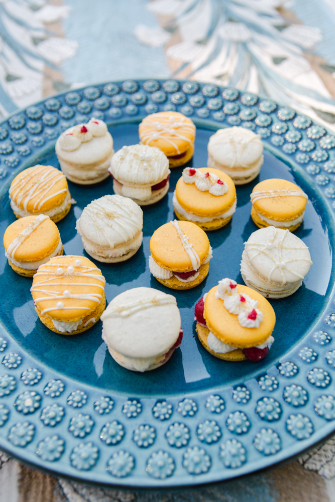 Macarons by Sugar Bee Bakery in Fairhope are set on a decorative blue plate.