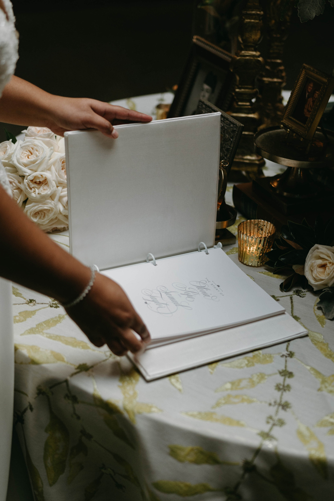 The Southern bride examines the guest book by Charming Scribe.