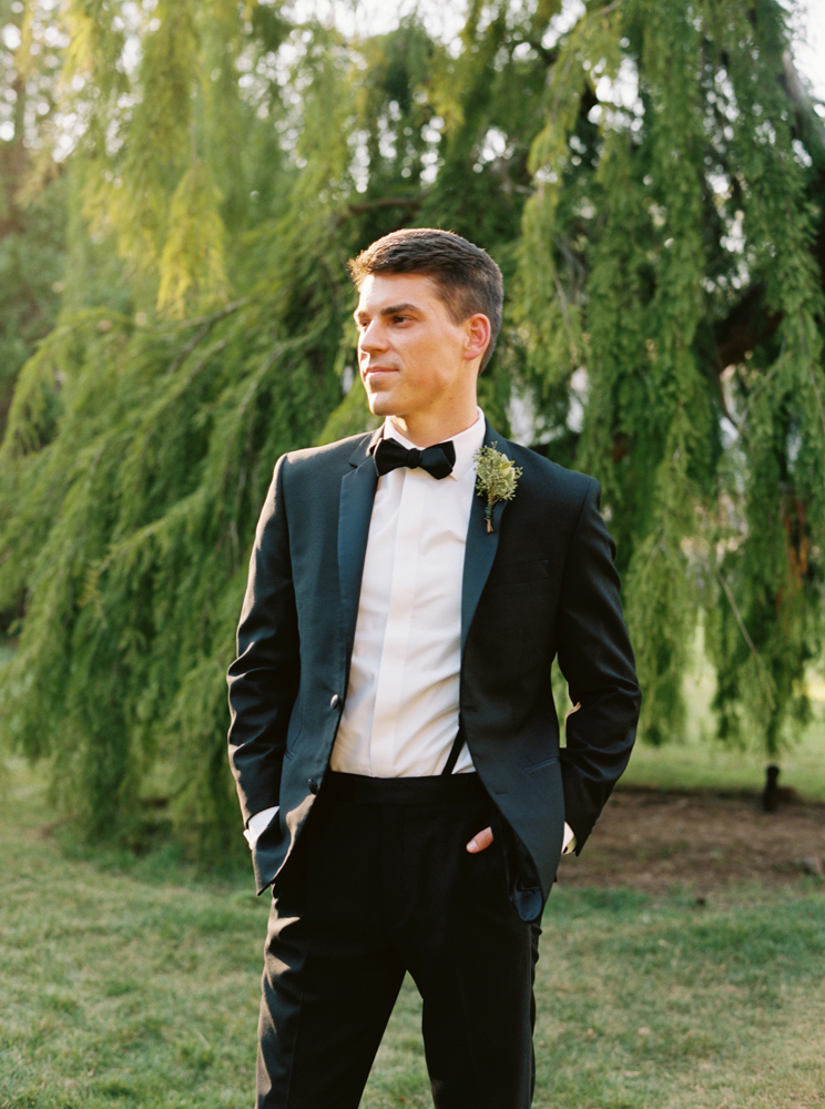 The groom stands in his classic tuxedo before his Southern wedding ceremony in Birmingham.