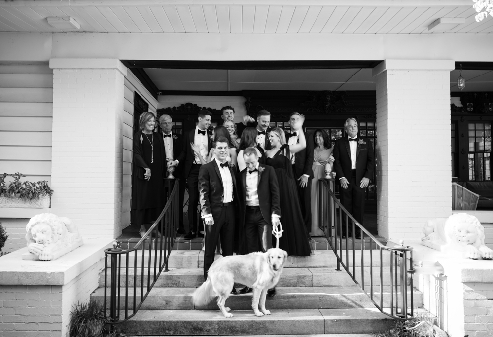 The grooms stand with their dog and family before their Southern wedding ceremony in Birmingham.