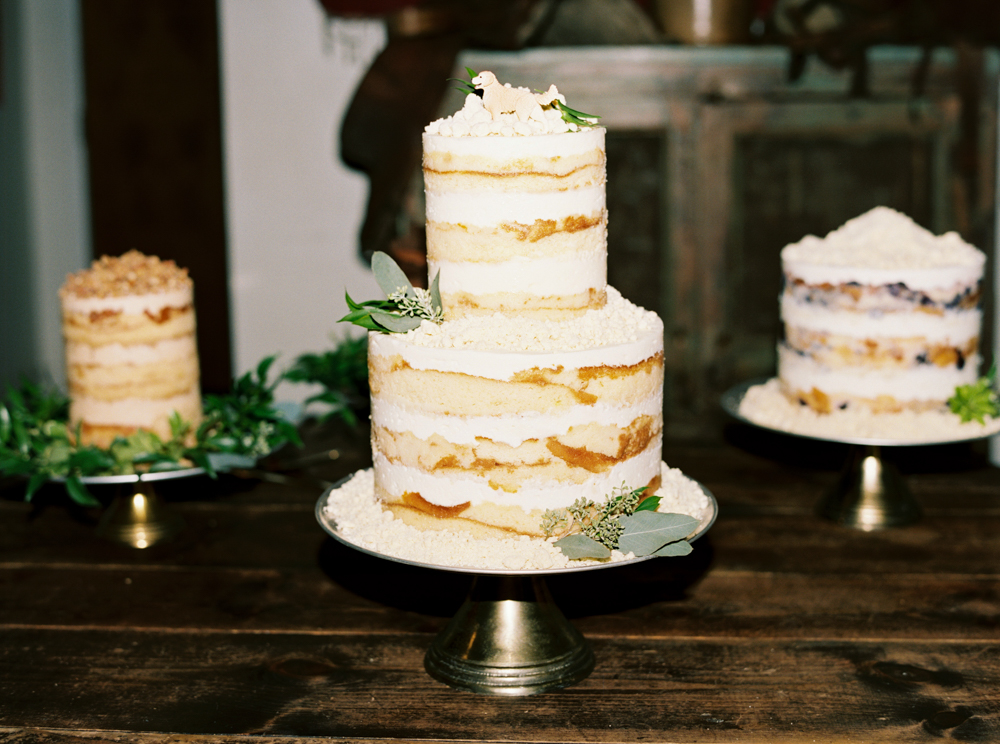 The Southern wedding cakes by Daughter's Baking are naked cakes decorated with eucalyptus.