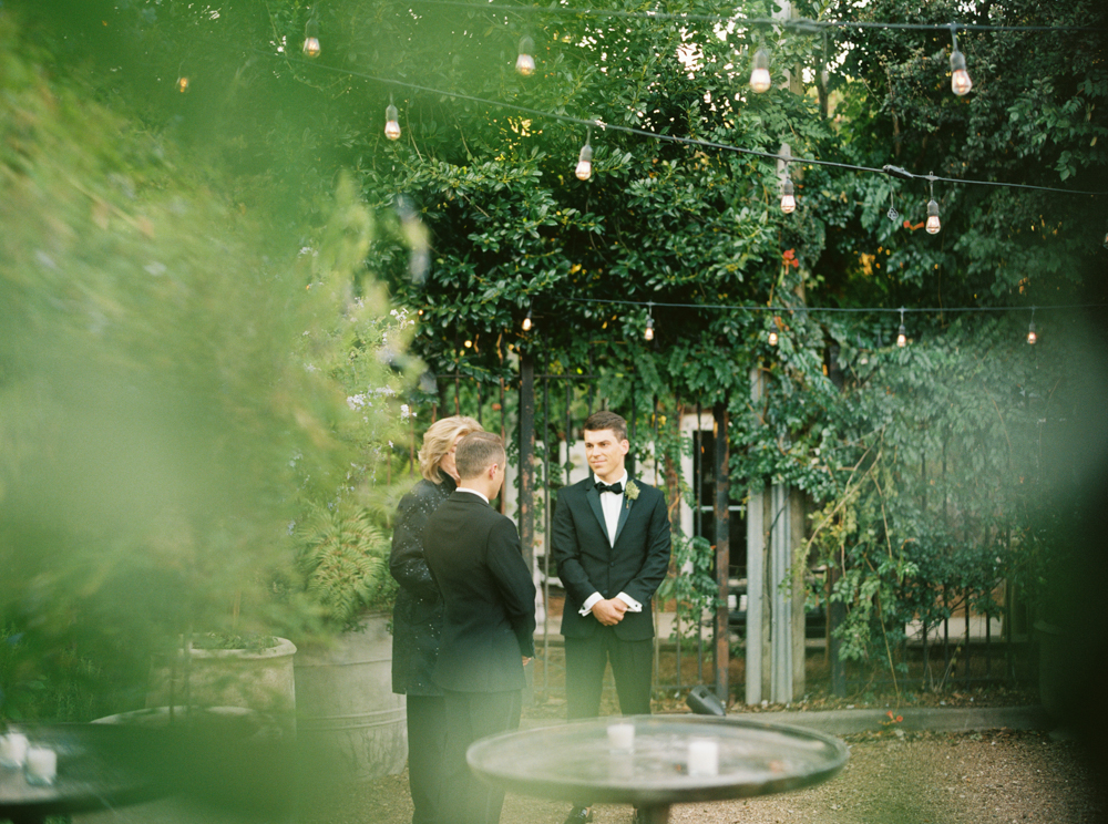 The groom's stand with the officiant before this Southern wedding at Ovenbird.