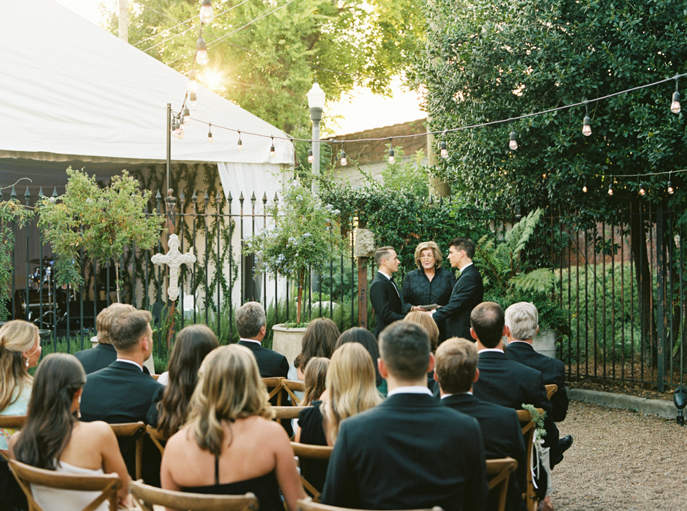 The grooms share their vows in a Southern wedding ceremony at Ovenbird in Birmingham.