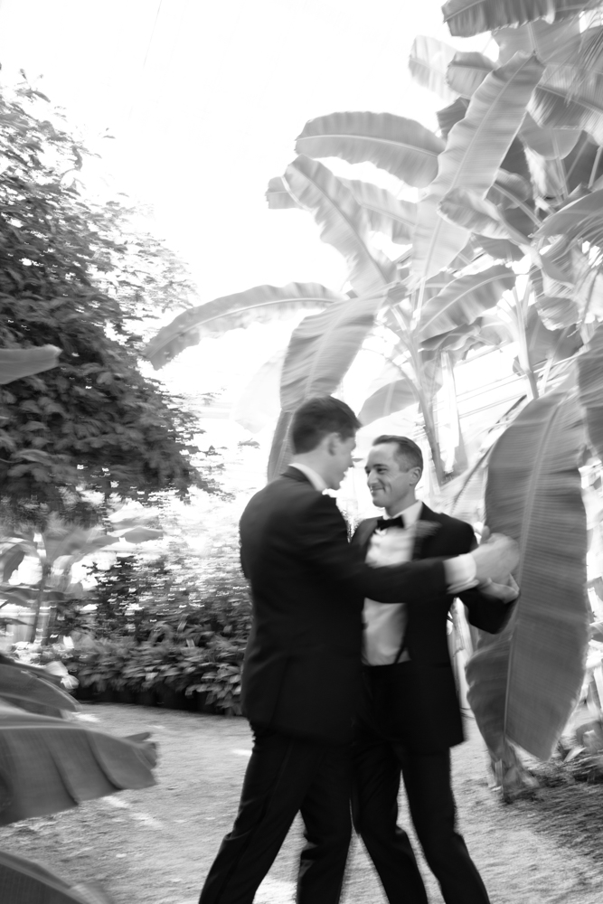 The grooms embrace at Birmingham Botanical Gardens.