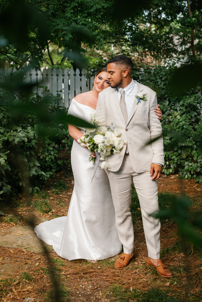 The bride embraces her groom in the garden before the Huntsville wedding.