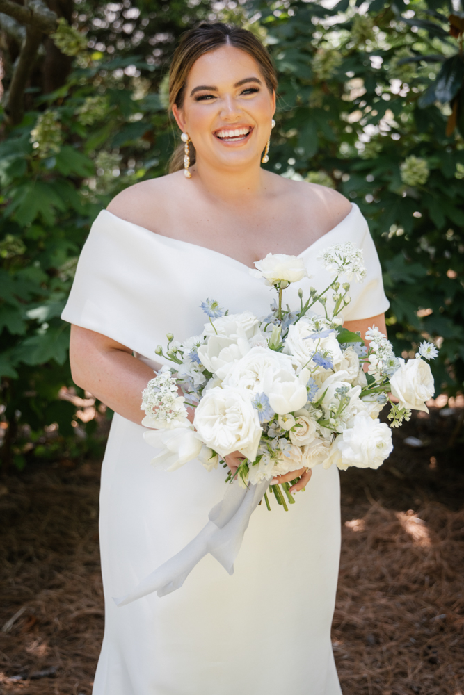 The bride smiles with her garden gathered bouquet in Huntsville, Alabama.