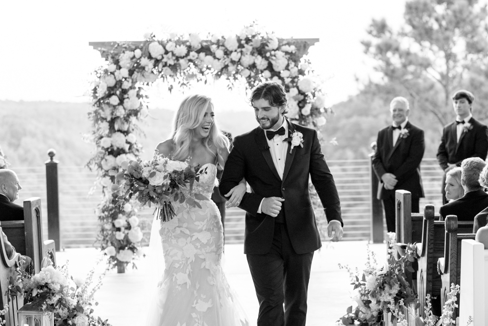 The bride and groom exit their wedding ceremony on the pavilion at Burns Bluff at High Falls.