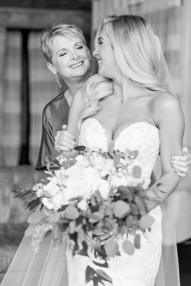 The mother of the bride embraces her daughter before the Southern wedding at Burns Bluff at High Falls.