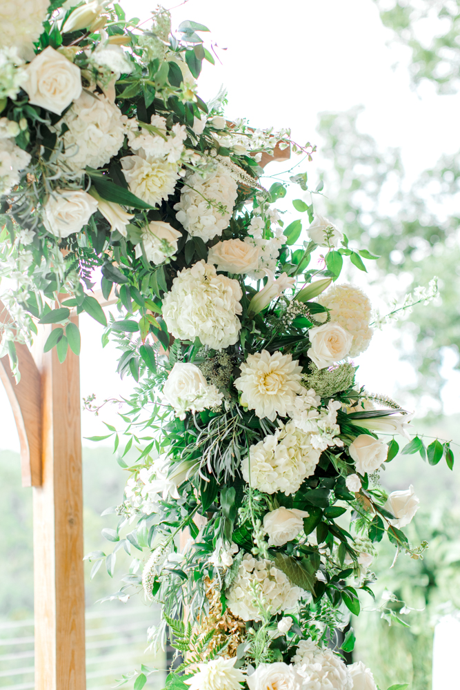 The floral arch at Burns Bluff at High Falls features white hydrangeas and dahlias.