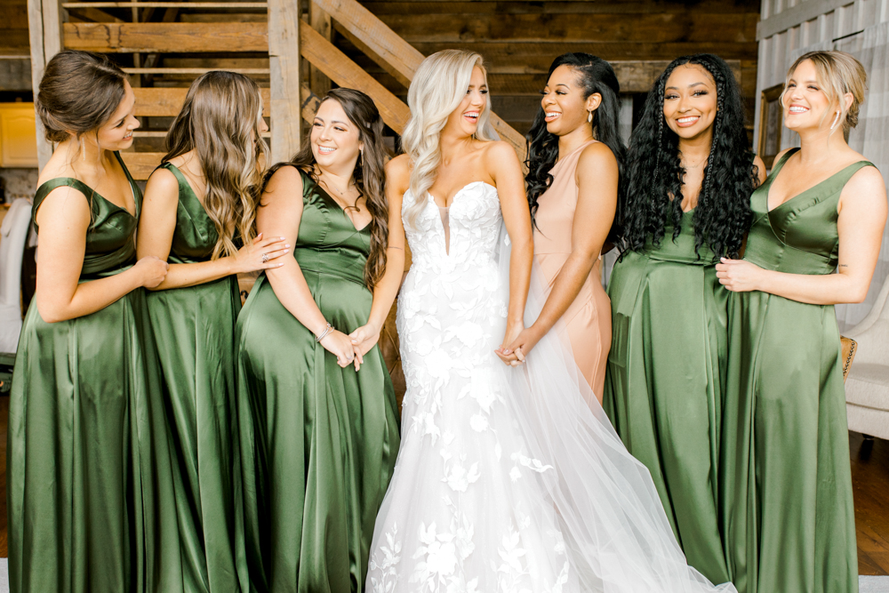 The bridesmaids stand with the bride in the lodge at Burns Bluff at High Falls.