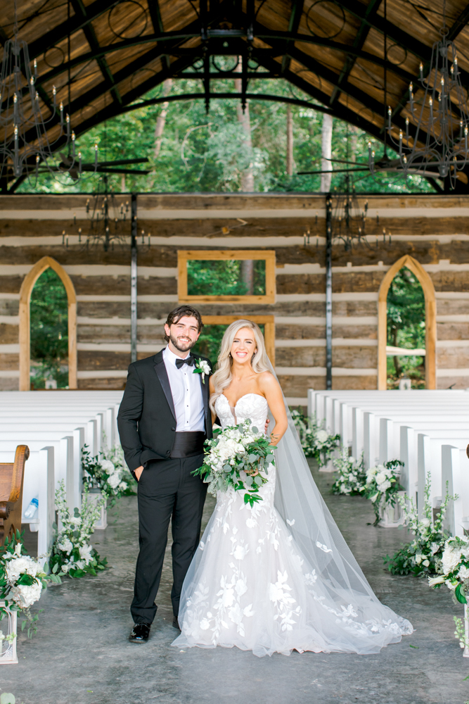 The bride and groom pose together on the pavilion at Burns Bluff at High Falls.