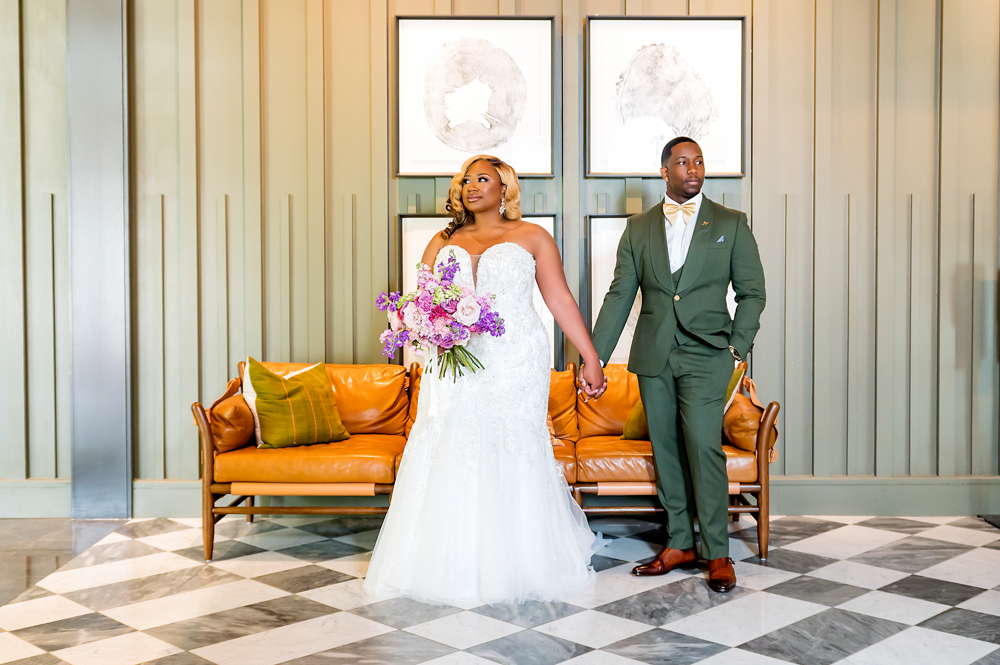 The bride and groom hold hands before the Birmingham wedding ceremony.