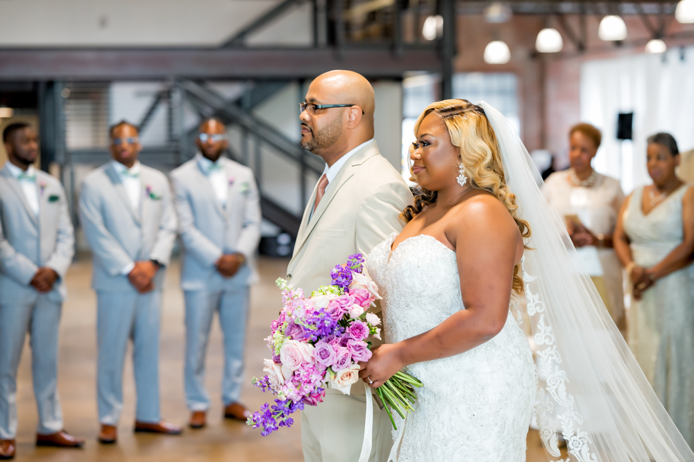 The father of the bride walks his daughter down the aisle of this Birmingham wedding ceremony.