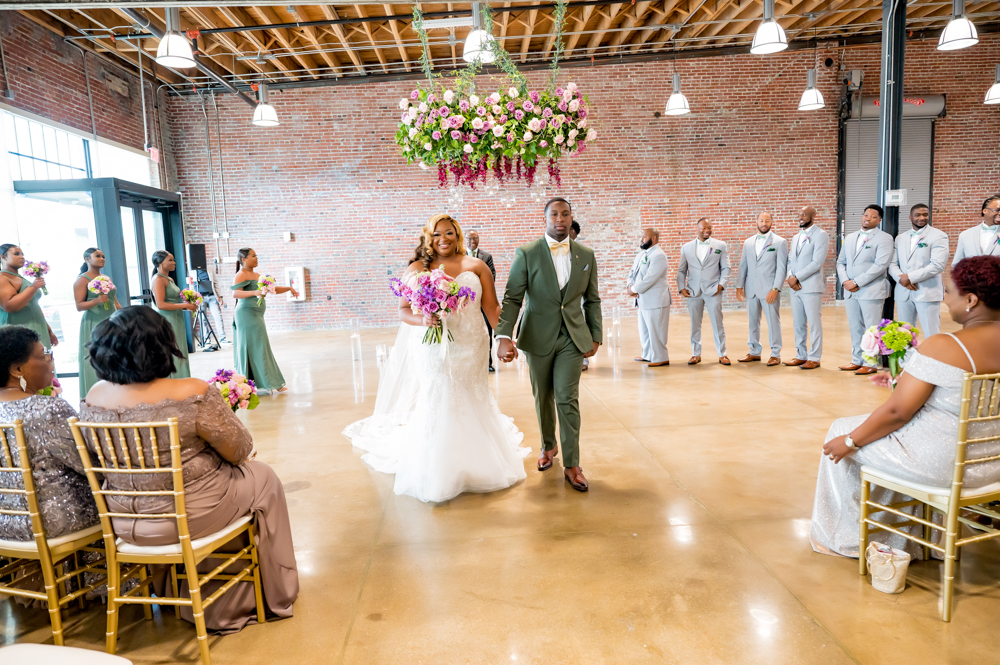 The bride and groom exit their Birmingham wedding ceremony.