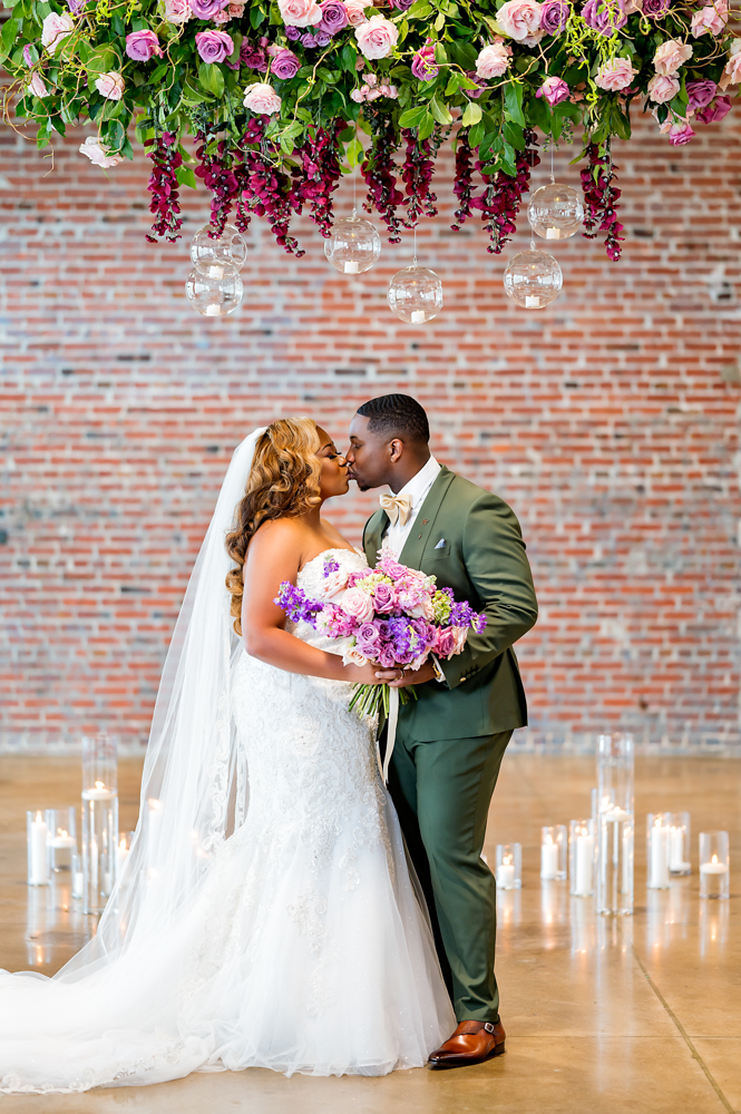 The bride and groom kiss during their Birmingham wedding reception.