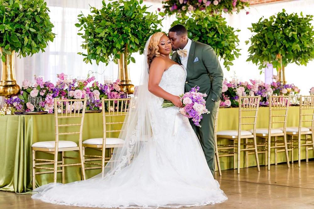 The groom kisses the bride before their Alabama wedding reception.