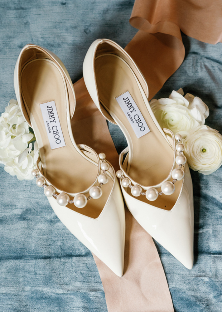 The Jimmy Choo shoes are photographed with flowers and ribbons.