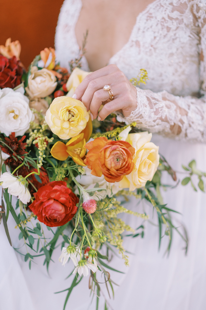 The bride holds a bouquet of autumn flowers for this Southern wedding.