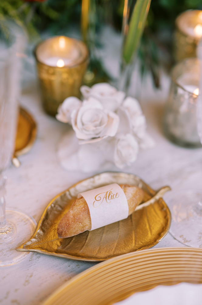 All guests names are hand-lettered on a personal baguette at each place setting for the French-inspired wedding style feature.