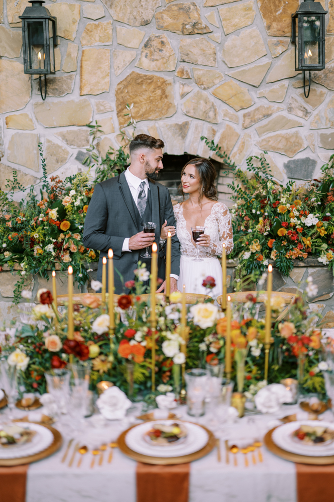 The bride and groom share a glass of wine during their Southern wedding reception at Otter Creek Farmstead.