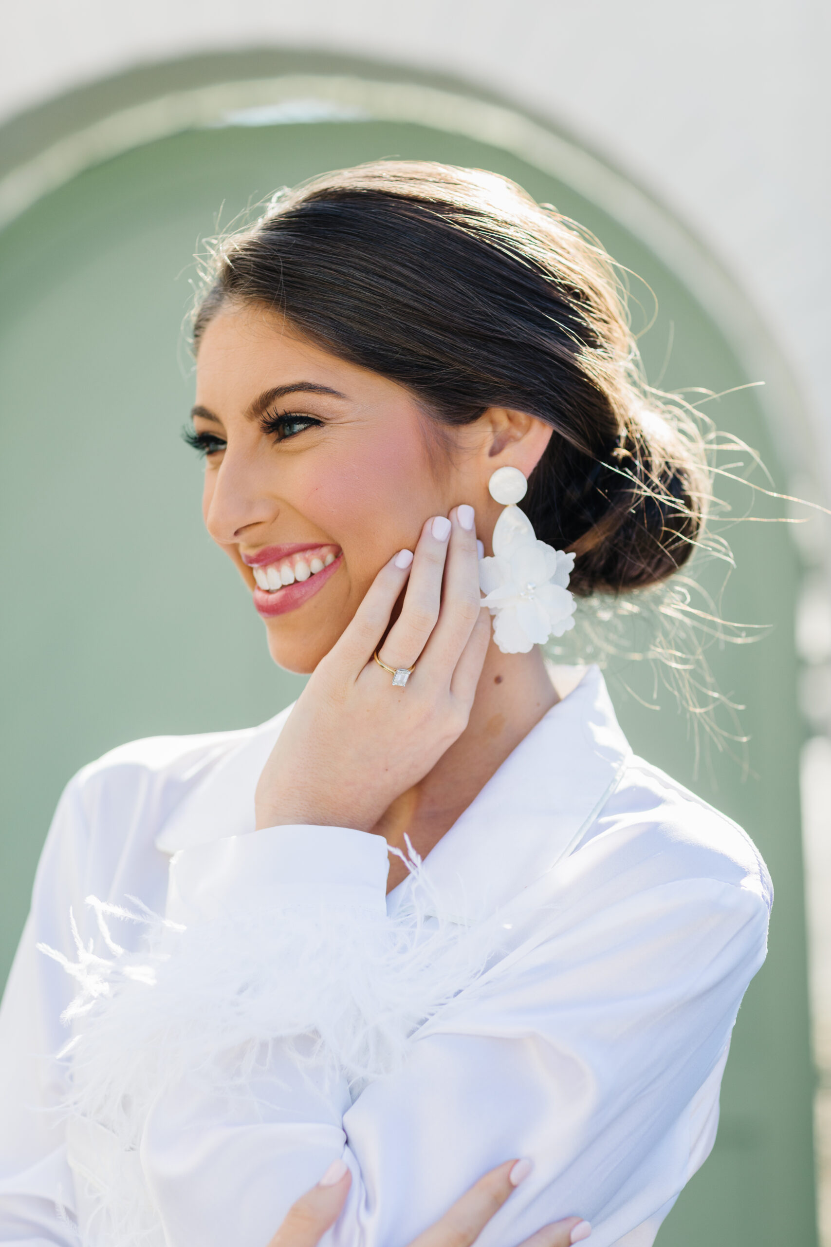 The bride wears her engagement ring and earrings before her Southern wedding.