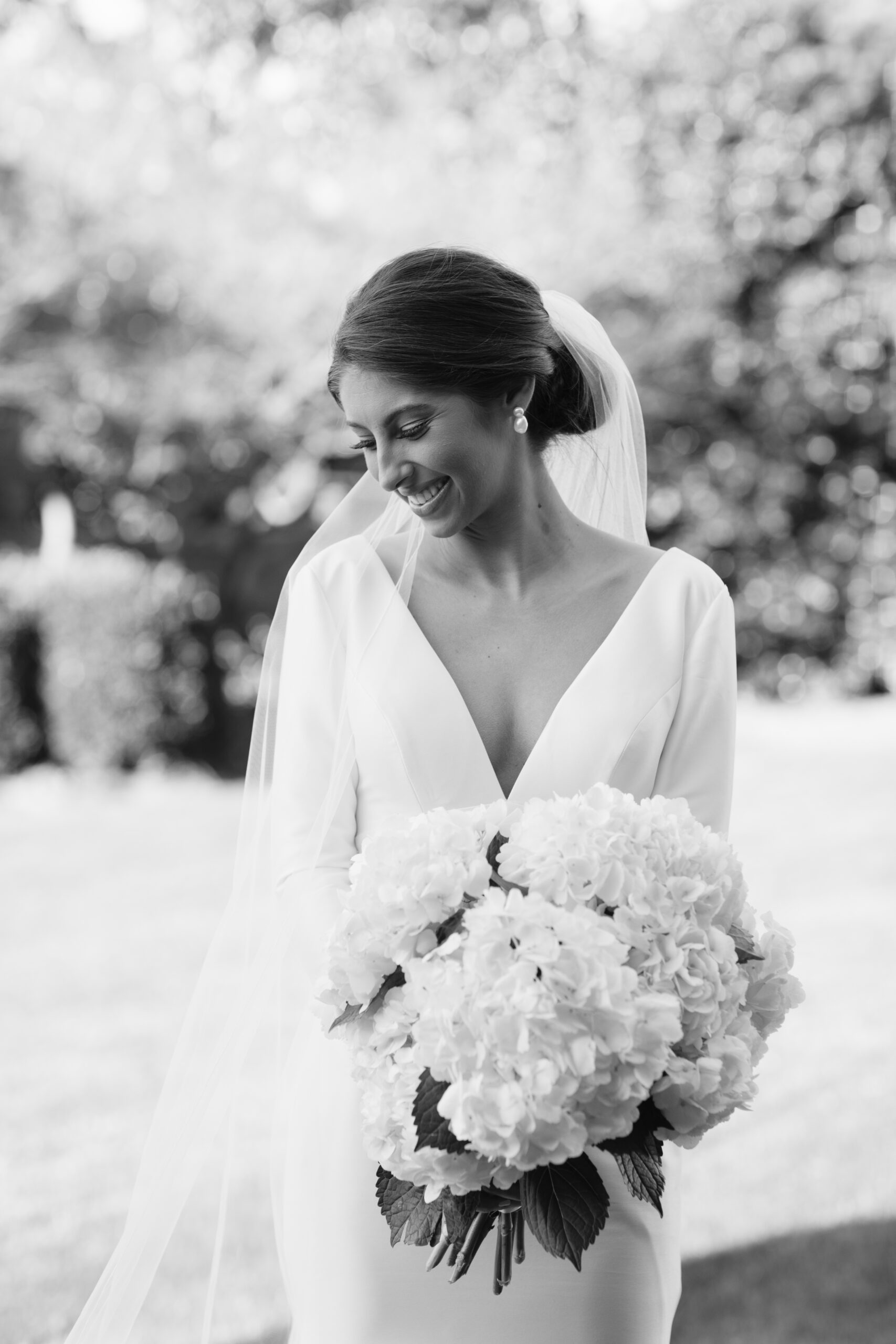 The bride poses with her bouquet of hydrangea flowers for her Southern wedding.