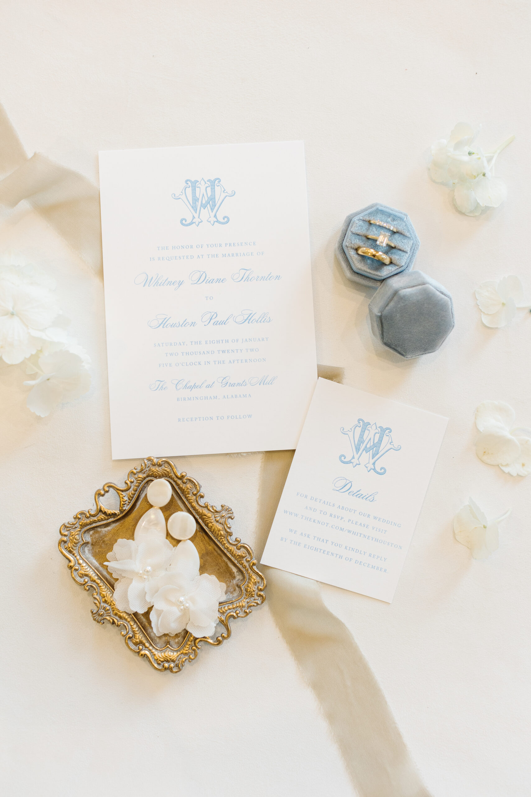 Wedding invitations are styled in a lay flat for wedding detail photography.