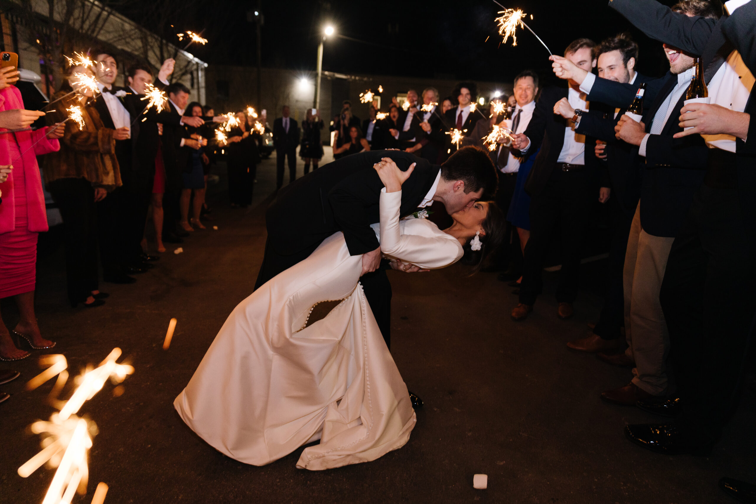 A bride and groom kiss after their wedding reception at The Farrell in Homewood, Alabama.