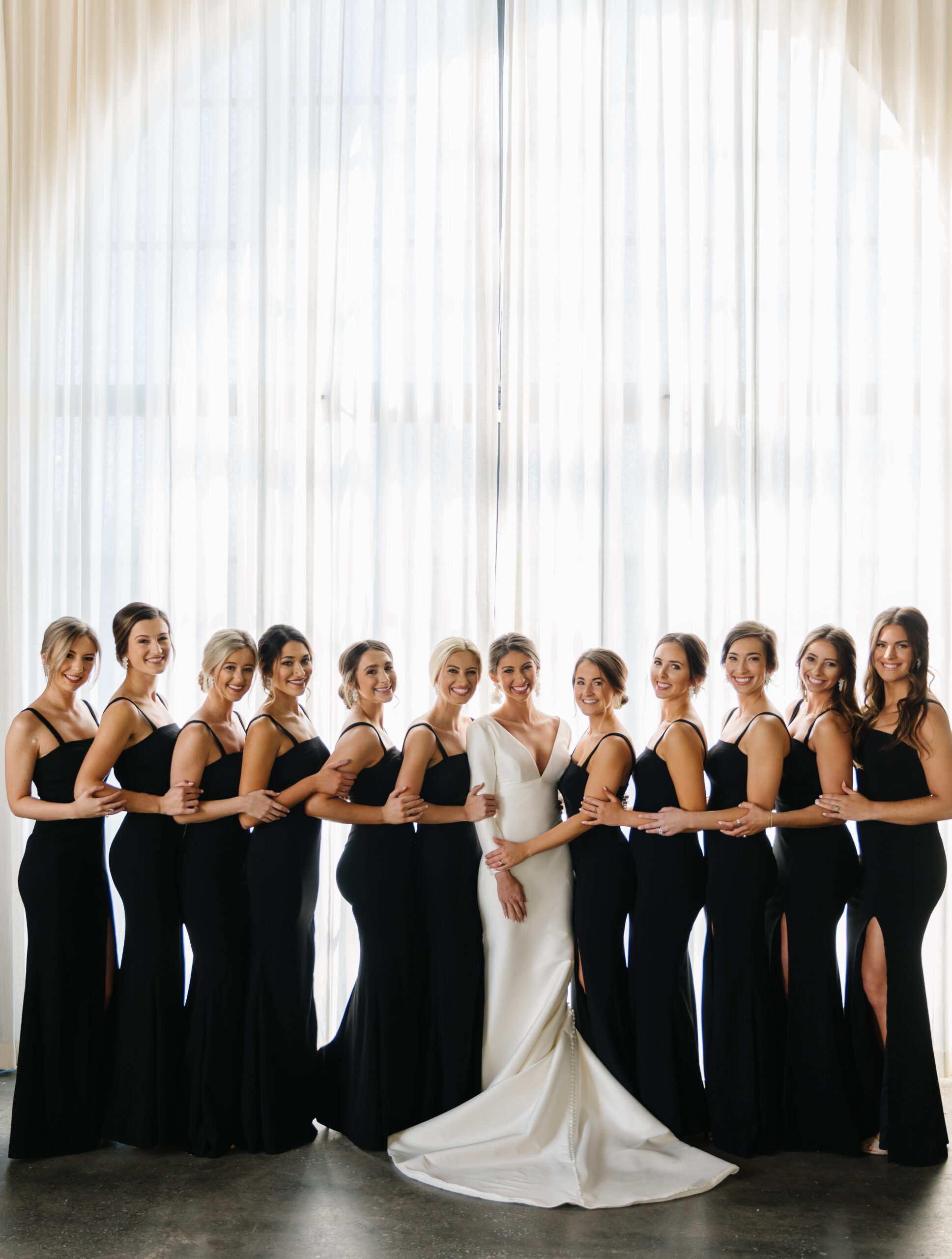 The bride and her bridesmaids pose together at The Farrell in Homewood, Alabama.