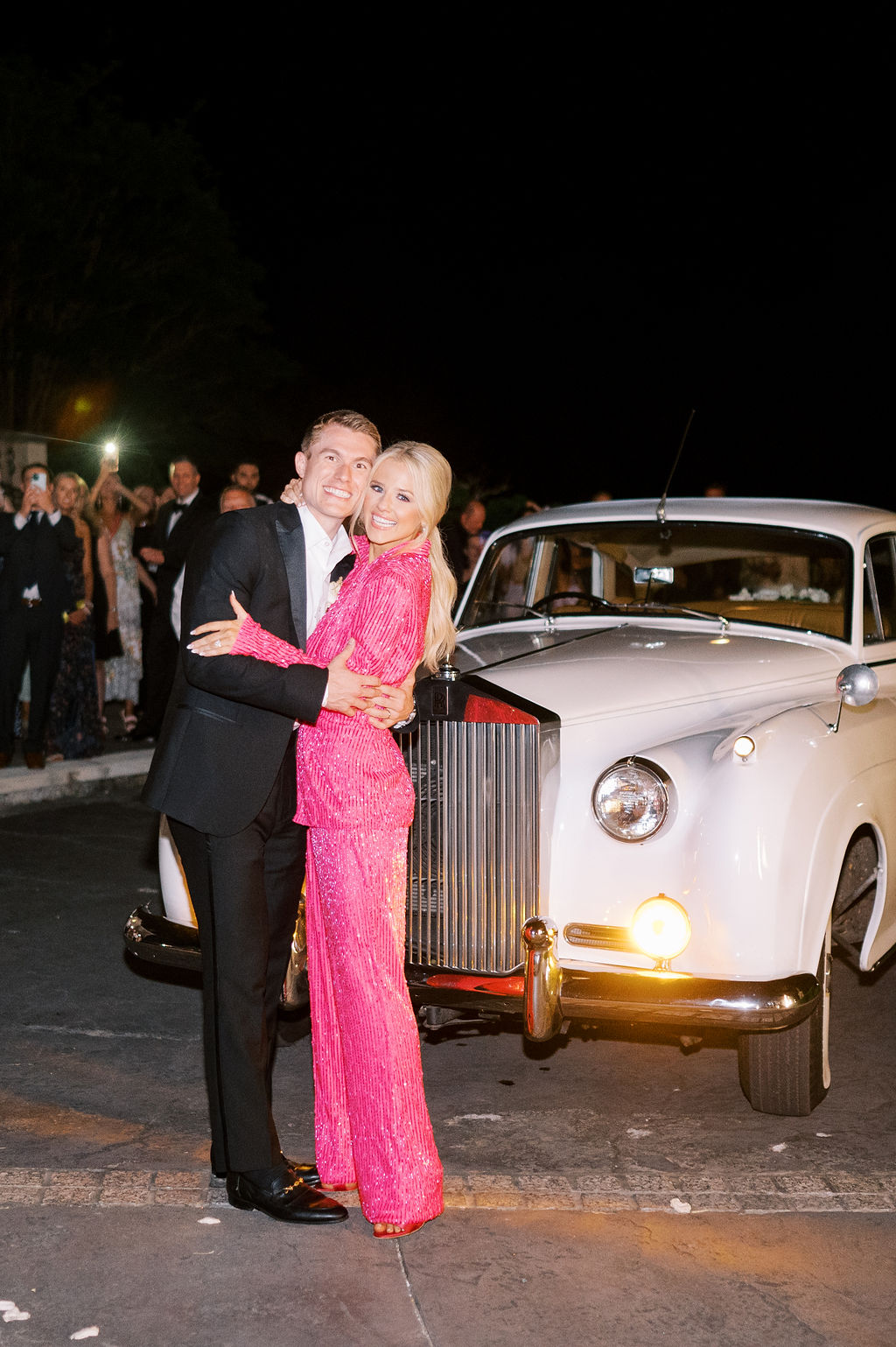 The Southern bride wears a hot pink suit after her wedding reception.