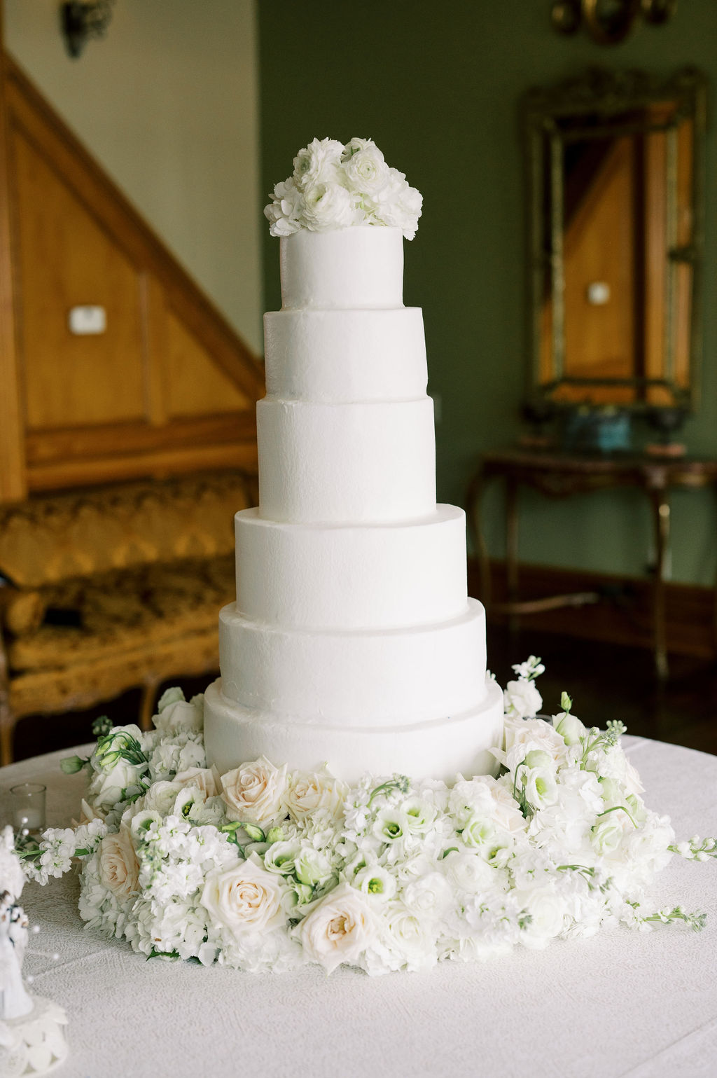 The classic wedding cake is decorated with white flowers at Fountainview Mansion in Auburn.