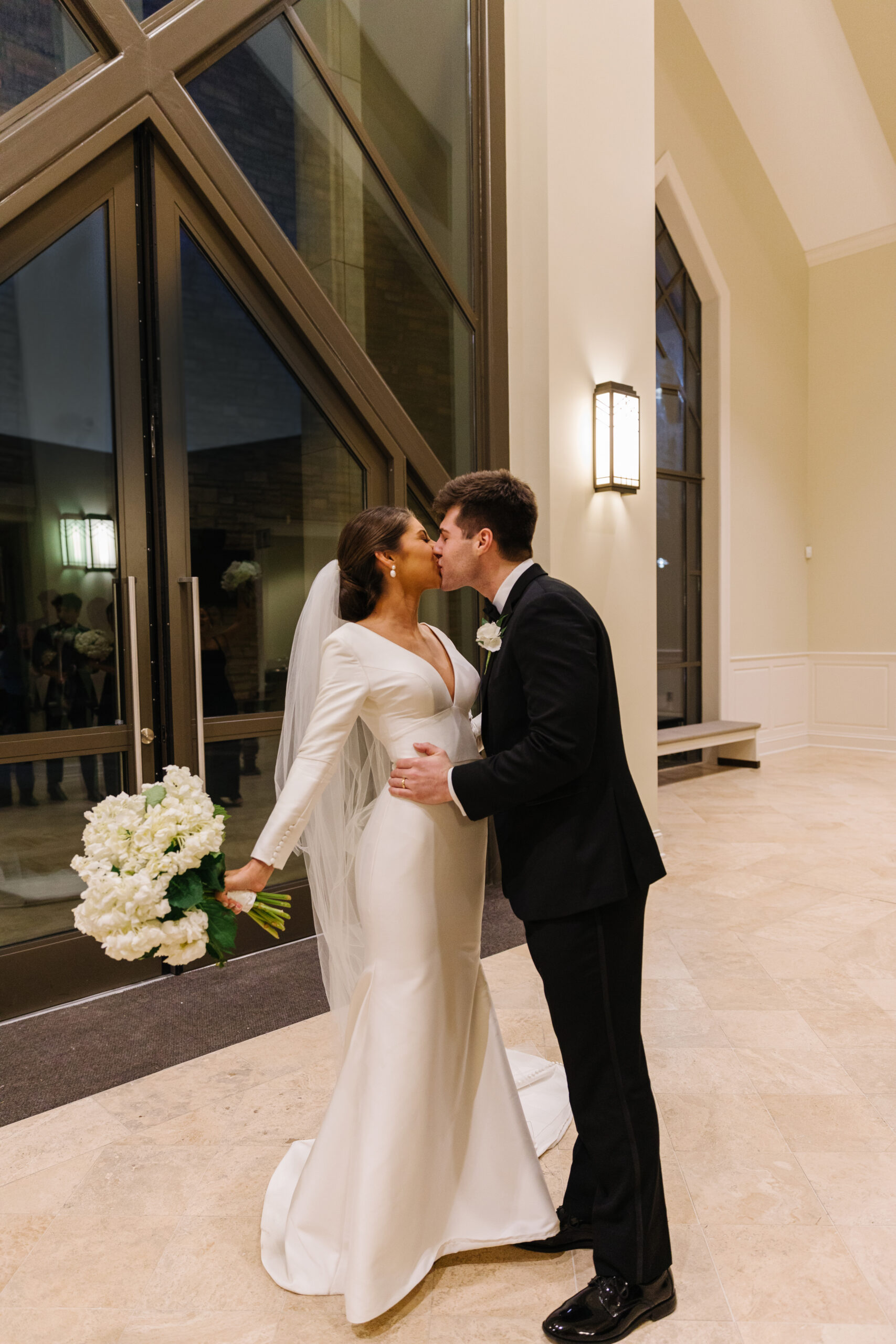 The bride and groom share a kiss after their wedding ceremony.