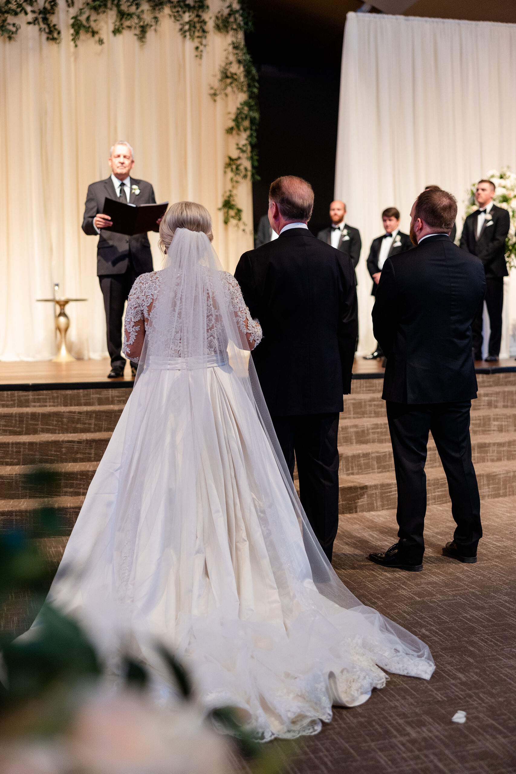 The father of the bride gives away his daughter during this Alabama wedding ceremony.