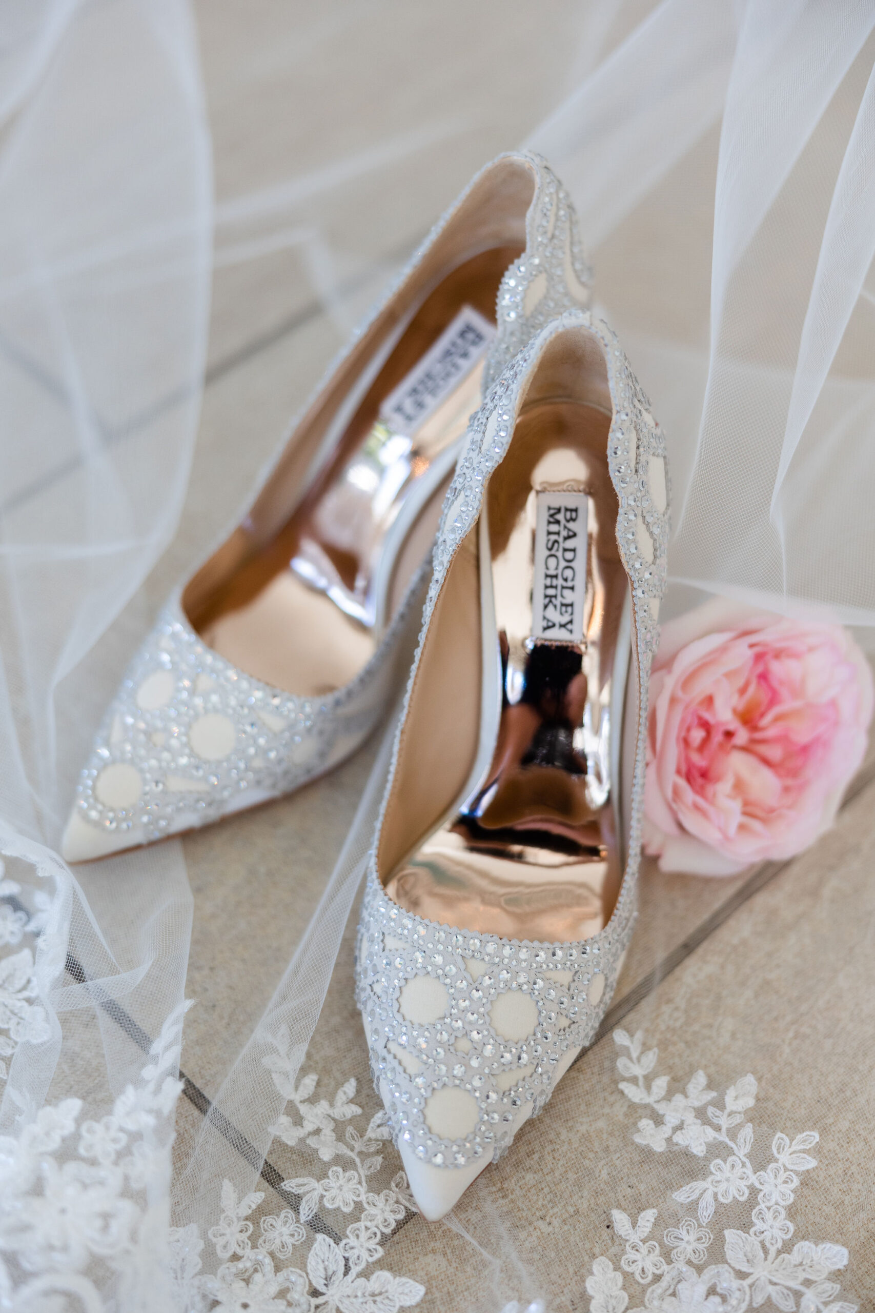 The bride's shoes are shown with her wedding veil.