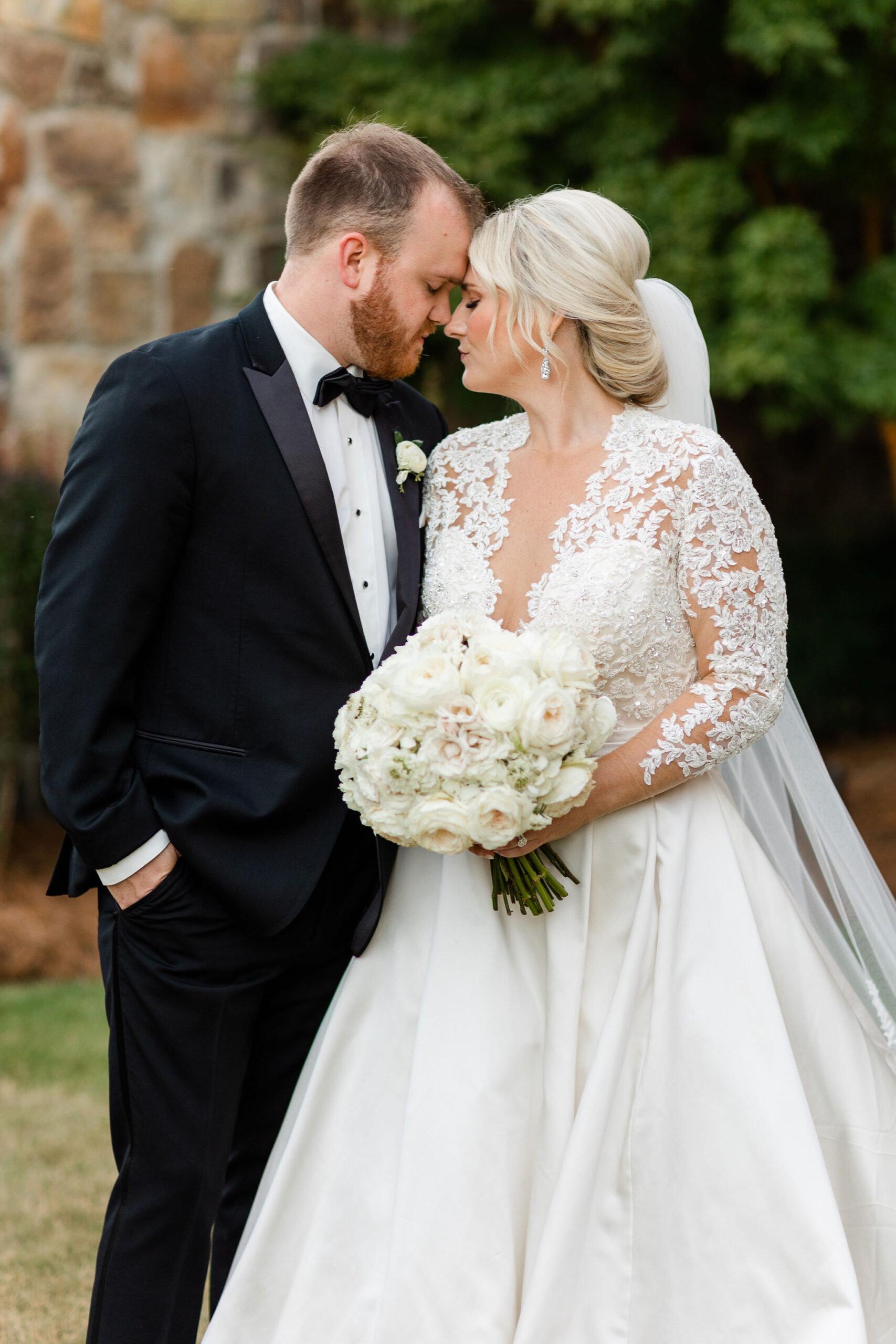 The bride and groom touch foreheads before their Alabama wedding at Grand Bohemian Hotel Mountain Brook.