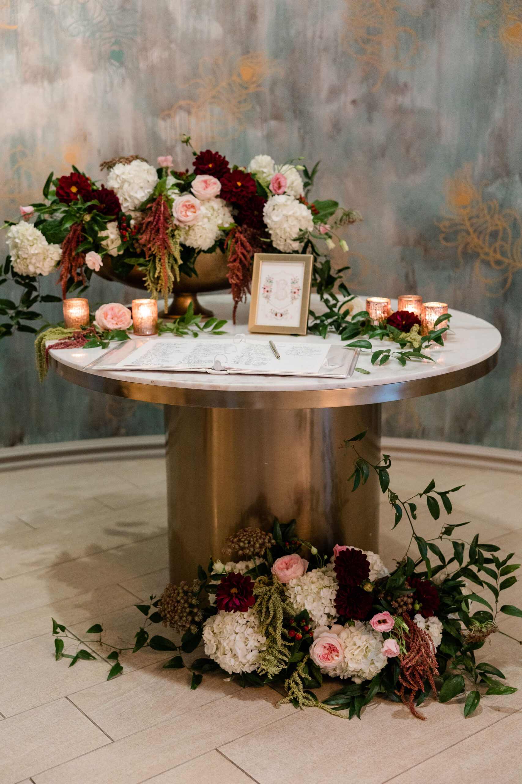 The entrance table for this Southern wedding at Grand Bohemian Hotel Mountain Brook is decorated with flowers.