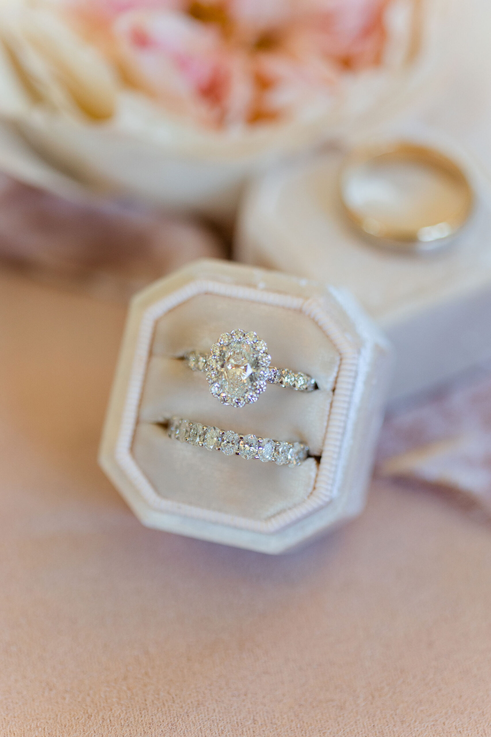 The wedding rings are displayed in a velvet ring box.