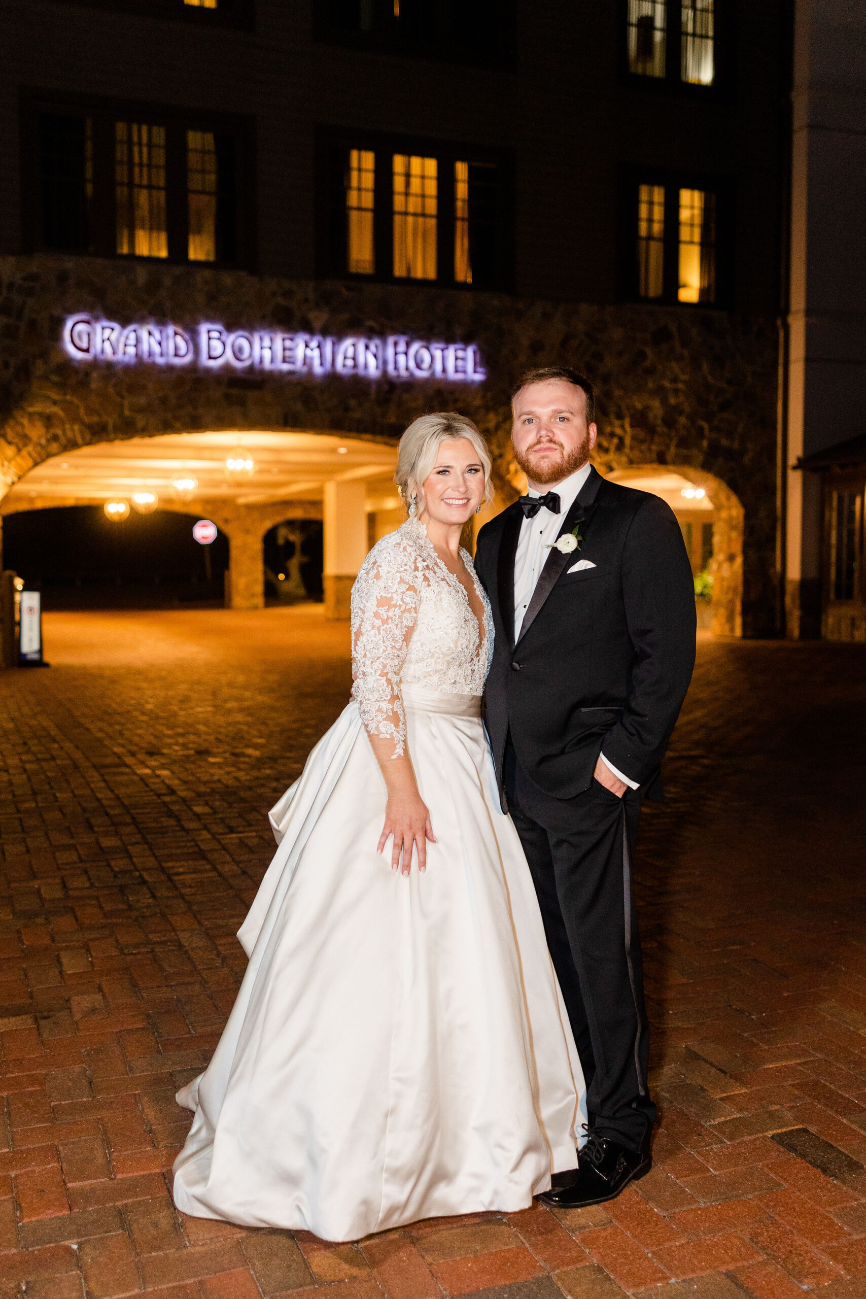 The bride and groom stand together outside Grand Bohemian Hotel Mountain Brook.