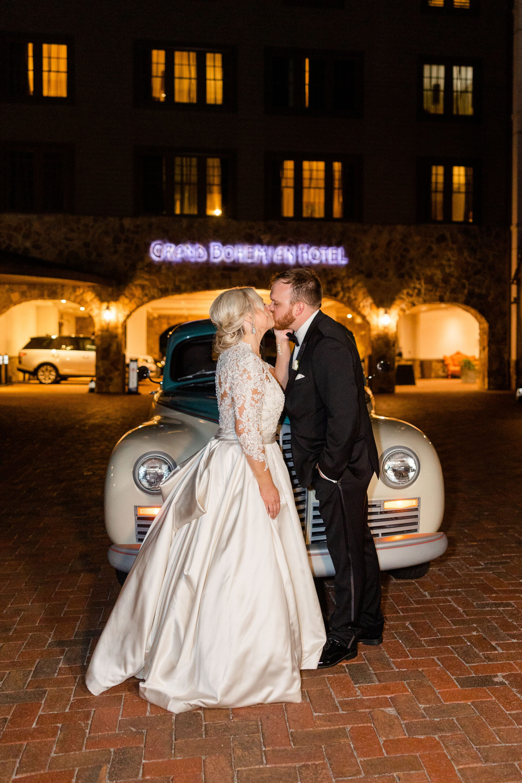 The bride and groom kiss outside Grand Bohemian Hotel Mountain Brook.