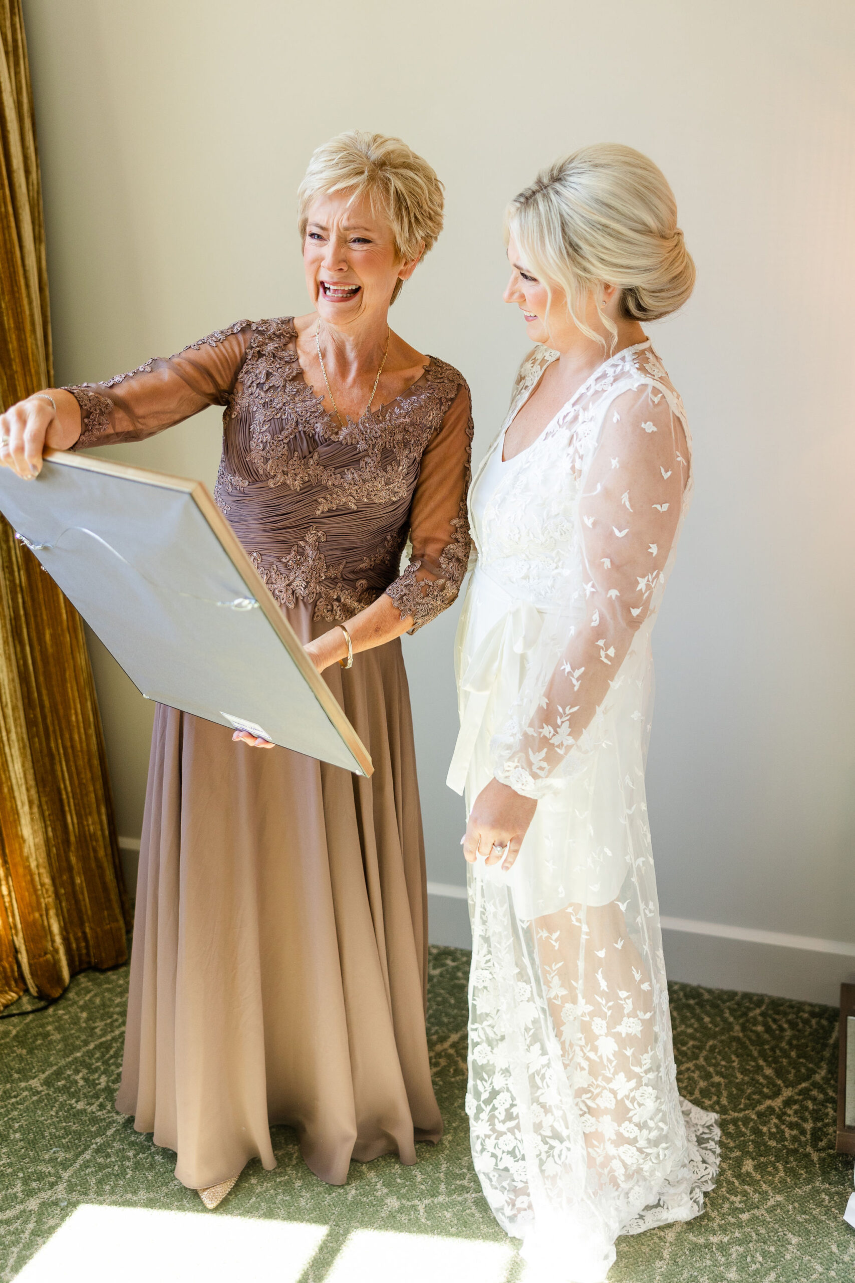 The mother admires framed art with her daughter at Grand Bohemian Hotel Mountain Brook.