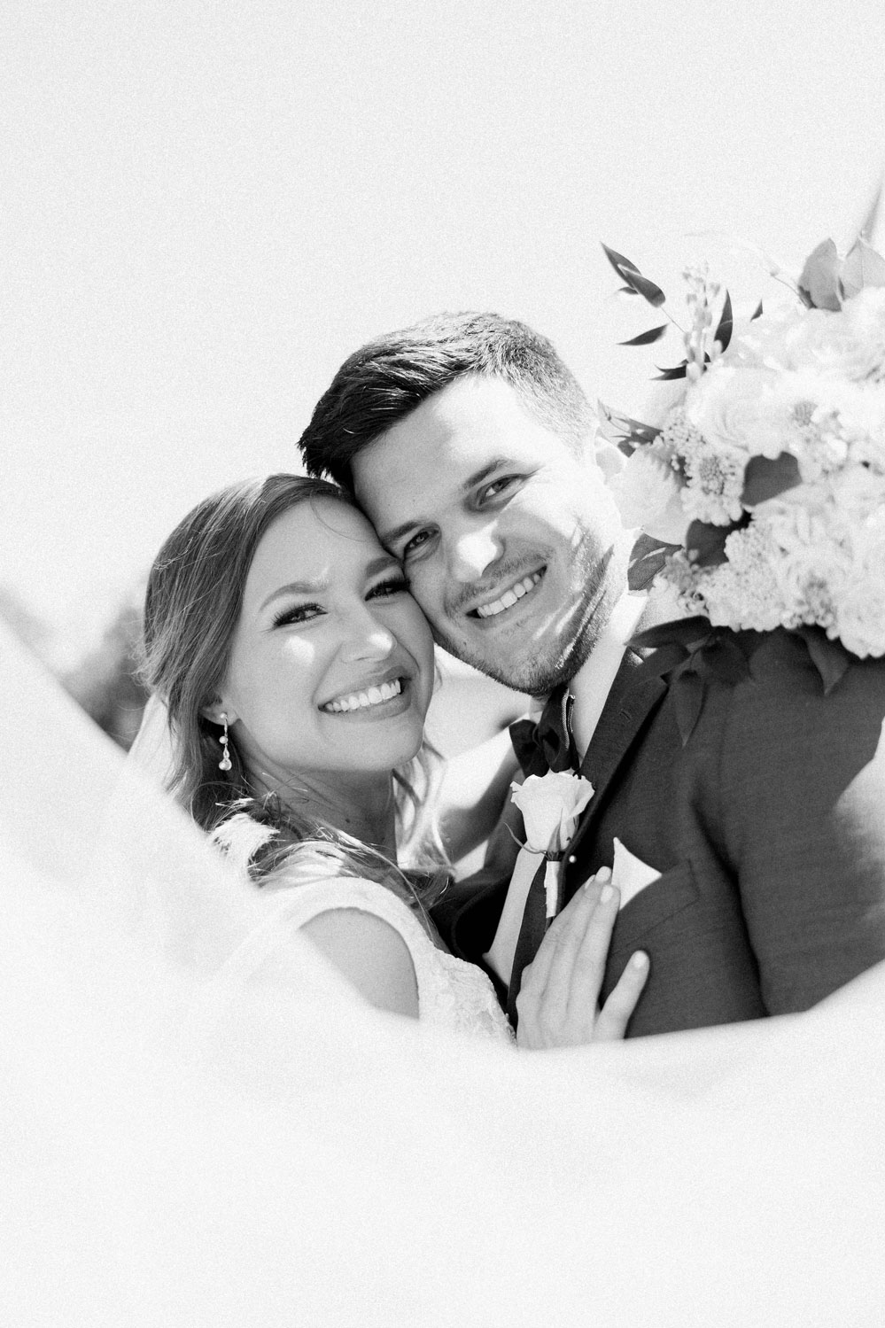 The bride and groom smile together before their Alabama wedding ceremony.