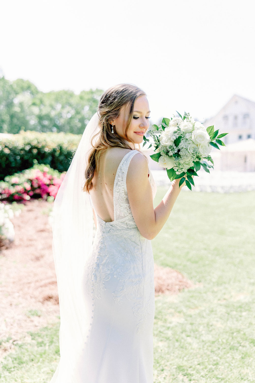 The bride holds her bouquet before her Alabama wedding.