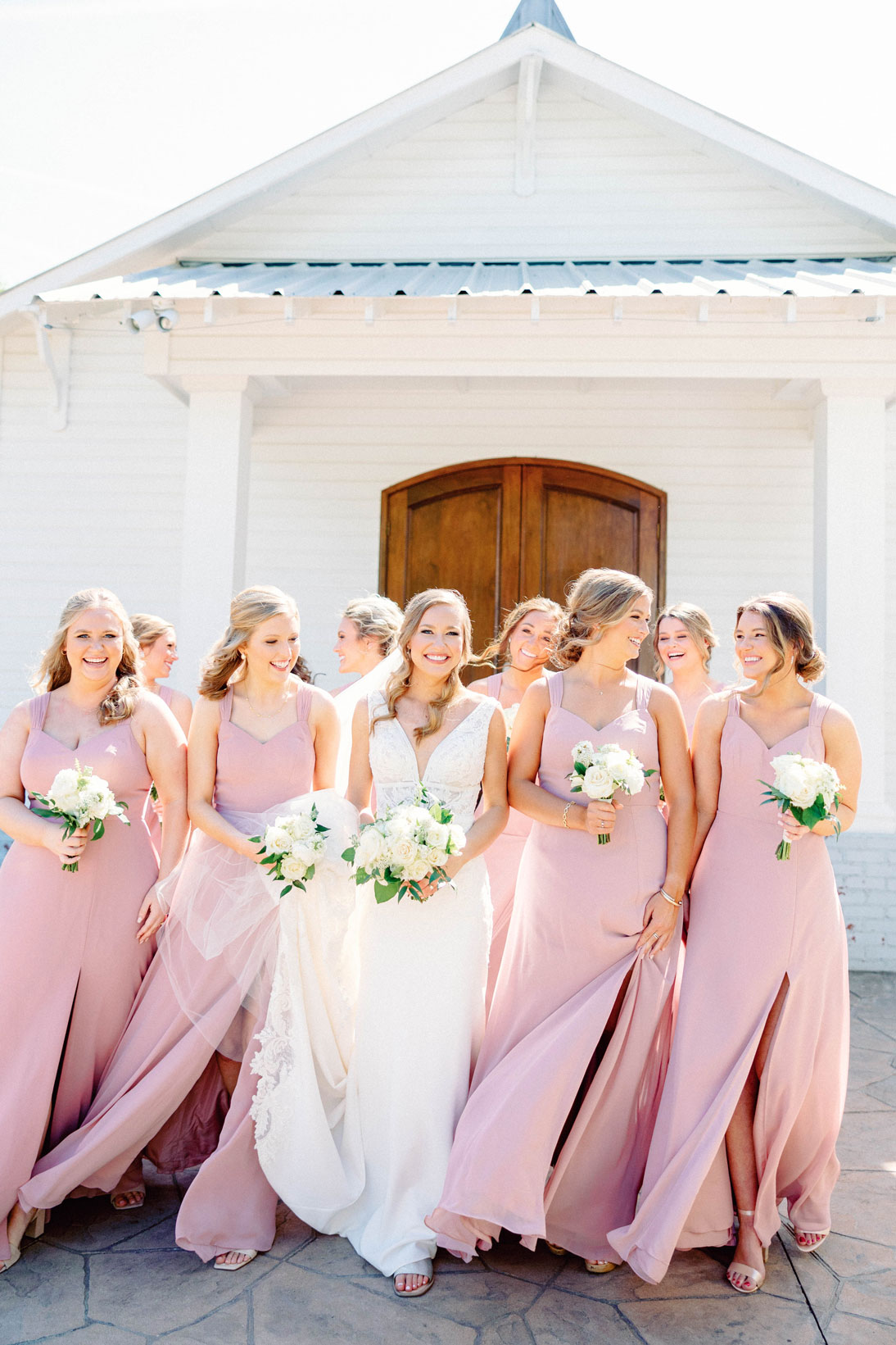 The bride walks with her bridesmaids before the Southern wedding.