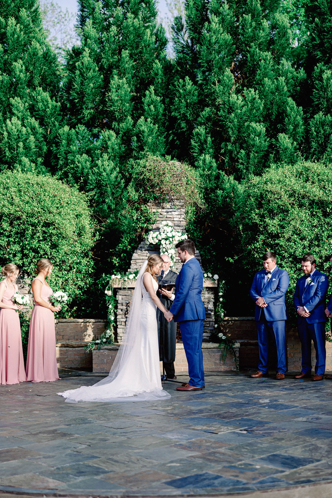 The bride and groom share their vows during their outdoor wedding ceremony at The Sonnet House.